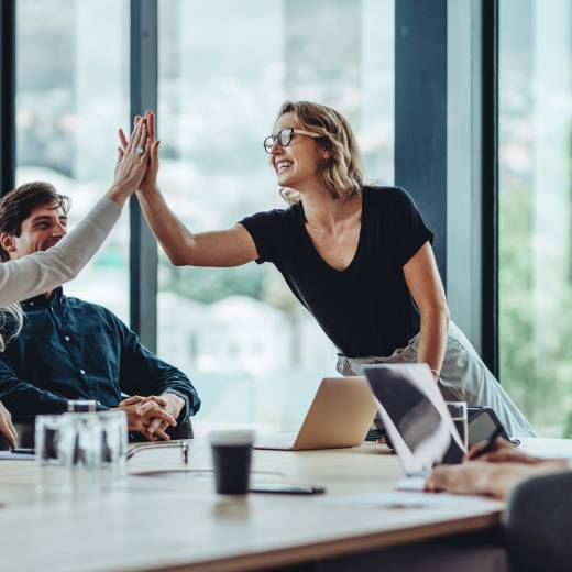 mensen aan tafel geven een high five
