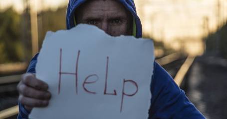 man houd papier omhoog met woord help erop