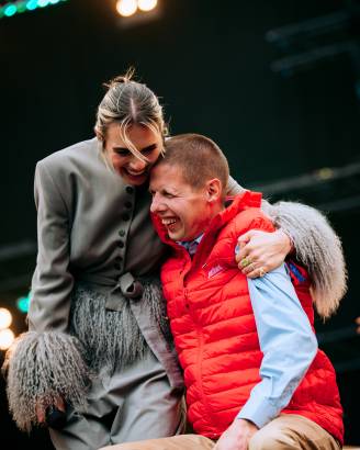maan en lid jostiband knuffelen op het podium