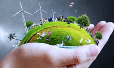 Hand met duurzame en groene wereld met windmolens