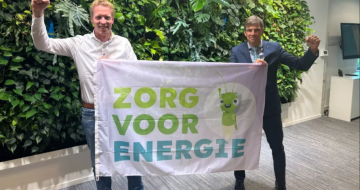Twee mannen houden spandoek omhoog met tekst zorg voor energie